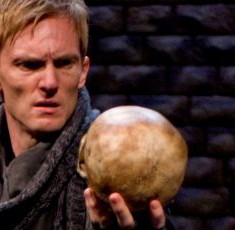 Scott Parkinson as Hamlet gazes at the skull of Yorick and contemplates death in Writers’ Theatre production of Hamlet 2012 credit Michael Brosilow